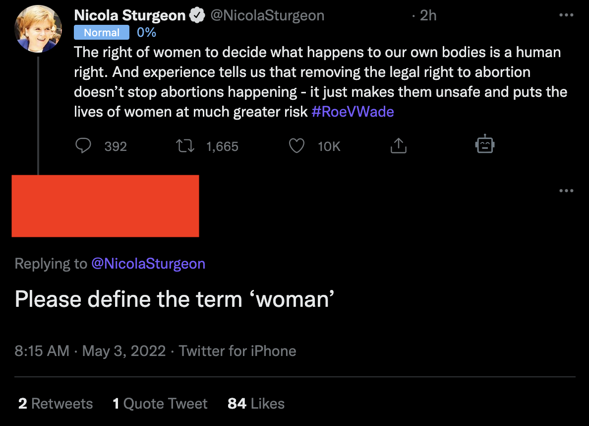 A screenshot of a twitter user replying to Nicola Sturgeon's tweet about Roe v Wade with 'Please define the term woman'.