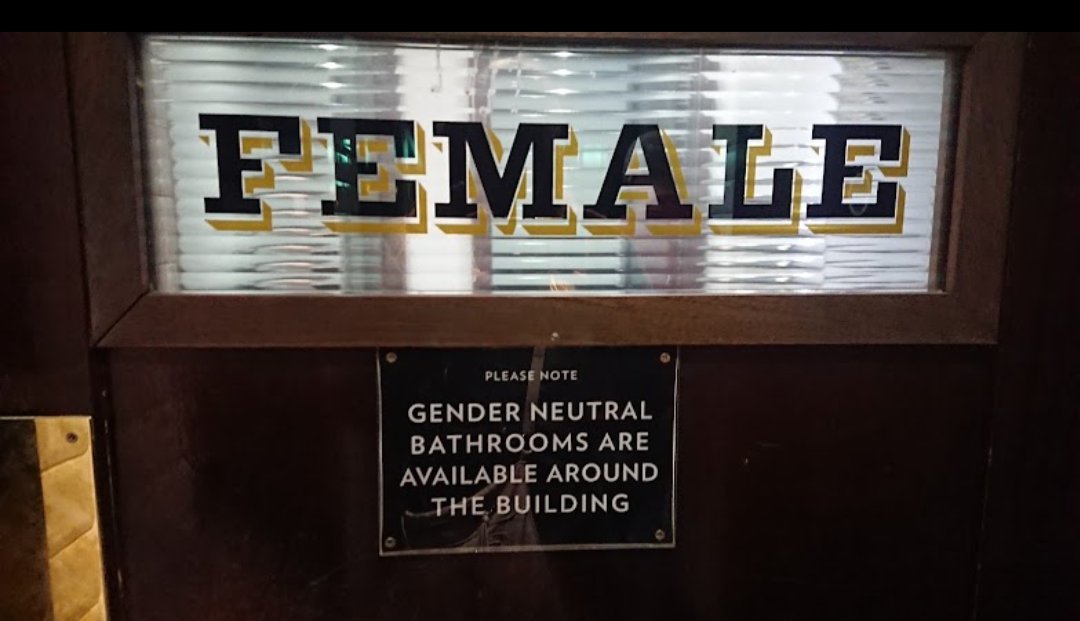 A door labelled 'Female'. A sign underneath the door reads: 'Please note gender neutral bathrooms are available around the building'